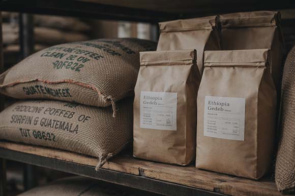 Coffee sacks and packed coffee bags prepared for café supply