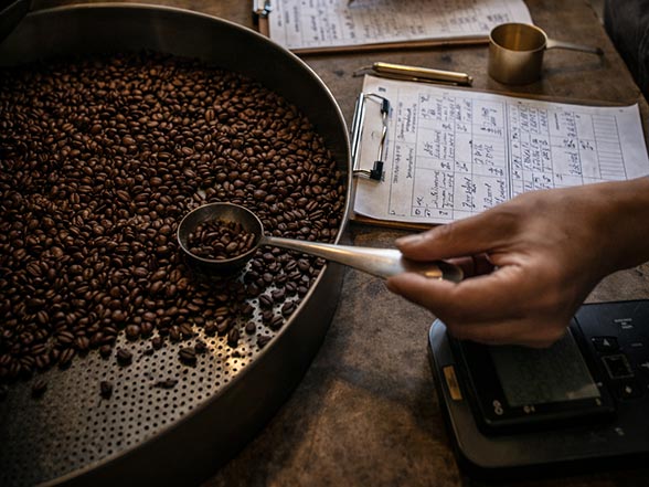 Roasted coffee cooling in a roasting tray during specialty coffee collaboration