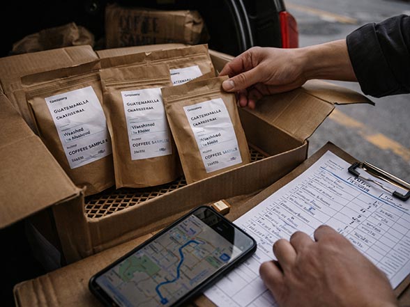 Packed coffee bags and notes prepared for distribution and market coordination